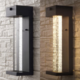 Turbo 5.13" Modern Industrial Iron/Glass Seeded Glass with Dusk-to-Dawn Sensor Integrated LED Outdoor Sconce