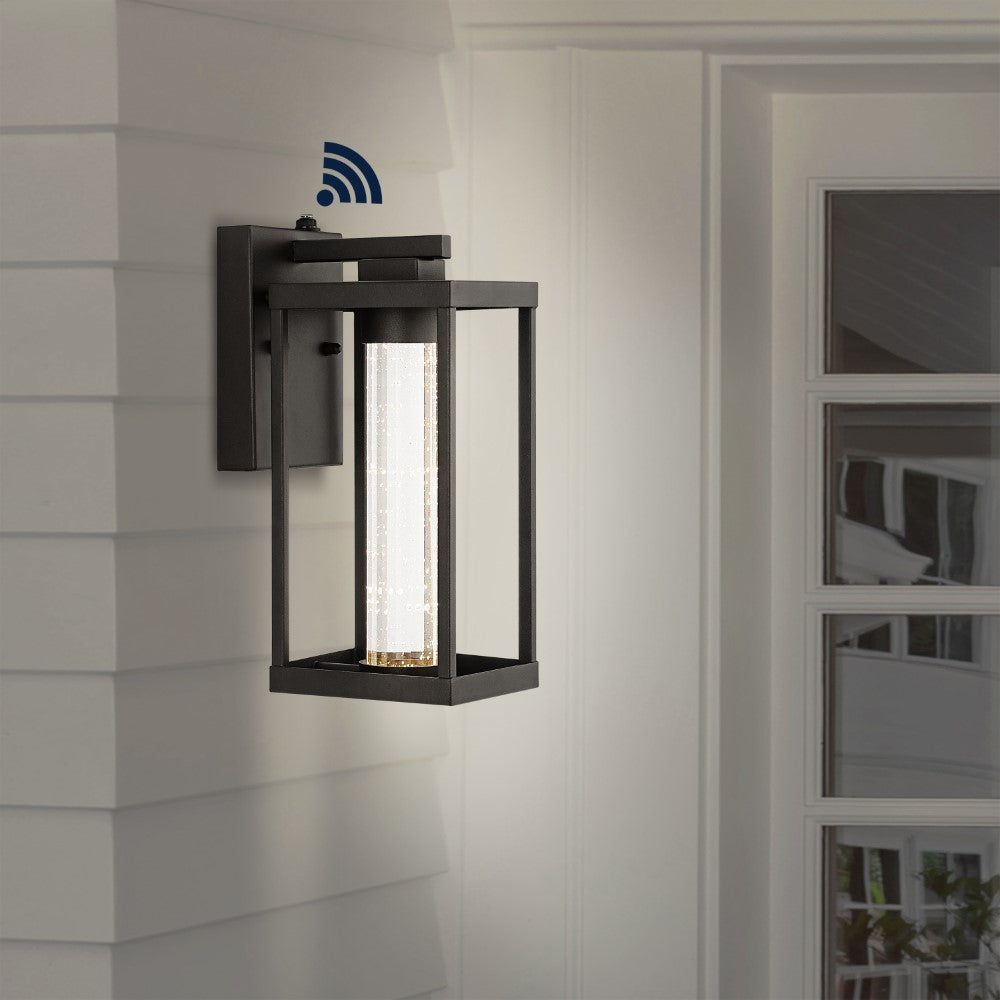 Shoji 4.75" Industrial Vintage Iron/Glass Seeded Glass with Dusk-to-Dawn Sensor Integrated LED Outdoor Sconce