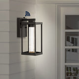 Shoji 4.75" Industrial Vintage Iron/Glass Seeded Glass with Dusk-to-Dawn Sensor Integrated LED Outdoor Sconce